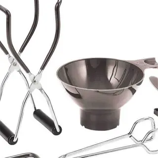 a canning kit with tongs, a funnel, a jar lifter, and other tools for preserving food