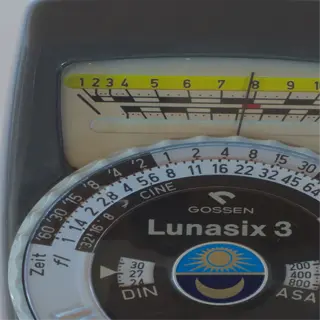 a close-up of a gossen lunasix 3 sunlight meter, showing its dials and scales for measuring light