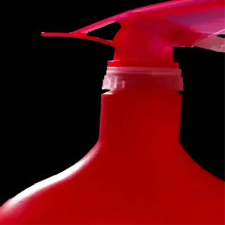 a close-up of a red plastic spray bottle with a clear trigger