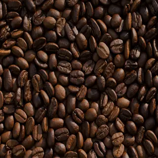 a close-up view of roasted coffee seeds, showcasing their rich brown color and texture