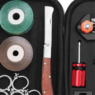 a grafting kit containing pruning shears, a knife, tape, clamps, and other tools for plant grafting
