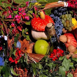 a harvest basket filled with fruits, vegetables, and flowers