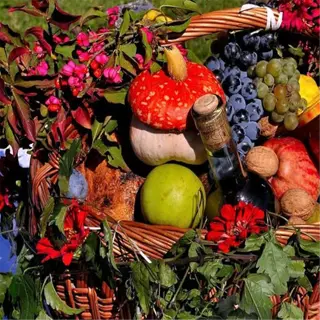 a harvest basket filled with fruits, vegetables, and flowers