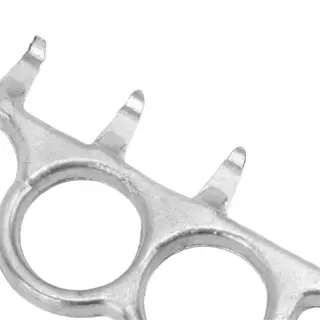 a metal tool with two finger holes and spikes, used for husk removal