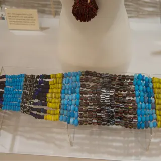 a multi-colored belt made of seed spacer beads on display