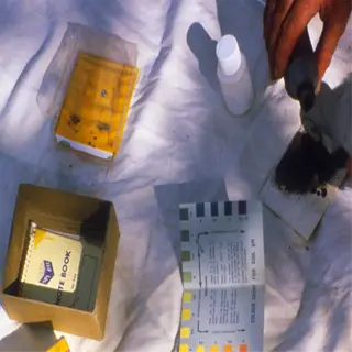 a person is using a soil ph test kit to test the ph level of soil