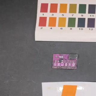 a ph test kit with a color chart and an orange ph indicator strip