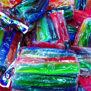 a pile of colorful freezer bags filled with assorted items, packed tightly for storage