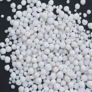 a pile of white, round calcium nitrate granules on a dark background