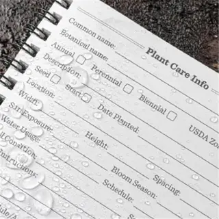 a plant care info logbook with soil ph section, wet from rain