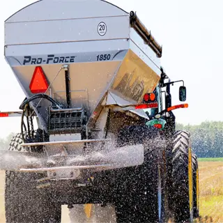 a pro-force 1850 fertilizer spreader in action on a field