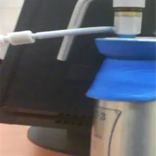 a small blue and silver sprayer tank with a nozzle on top