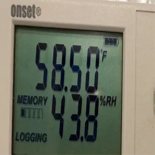 a temperature and humidity logger displaying 58.50°f and 43.8%rh