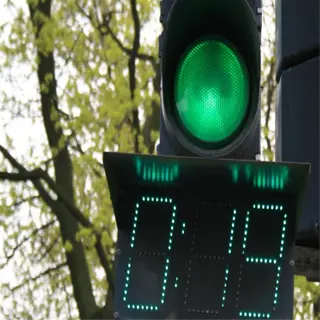 a traffic light with a green light timer showing 9 seconds