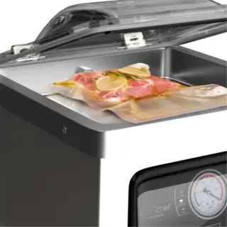 a vacuum sealer with various food items like meat and asparagus in sealed bags