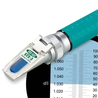 a vee gee stx-3 salinity refractometer with a calibration chart