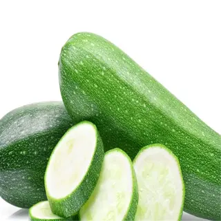 a whole zucchini and slices of zucchini on a white background