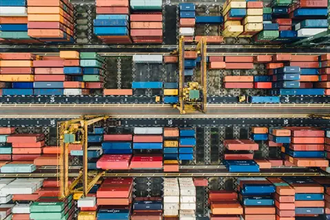 aerial view of organized shipping container terminal with colorful stacked containers and cranes - container selection for logistics