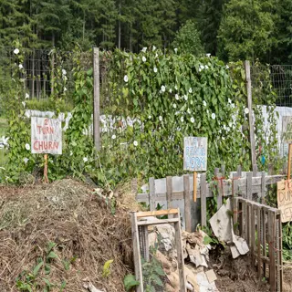 an organic compost bin area with signs and materials for composting