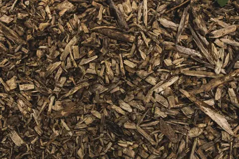 arborist wood chips pile: close-up texture of organic wood fragments and mulch debris in natural brown tones
