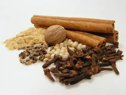 assorted spices featuring cinnamon sticks, whole cloves, nutmeg, and cinnamon clove powder
