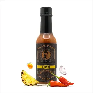 barbaro mojo piñazo vinegar hot sauce bottle with pineapple, chili, and onion, featuring text and a person's face on the label