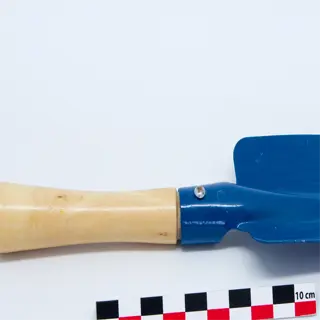 blue transplant trowel with wooden handle and ruler for scale
