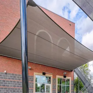 building entrance with large shade cloth canopy