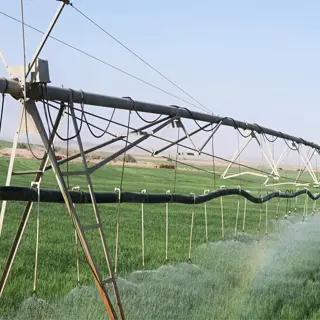 center pivot irrigation system watering a farm field