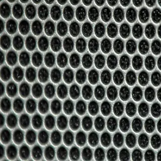 close-up of a metallic mesh screen with evenly spaced holes