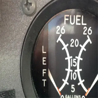 close-up of a tractor fuel gauge showing left and right tank levels