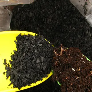close-up of biochar soil mix in a plastic bag with scoops