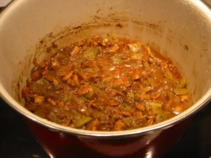 close-up of garlic chili mixture stew simmering in a pot with mushrooms, bell peppers, and herbs