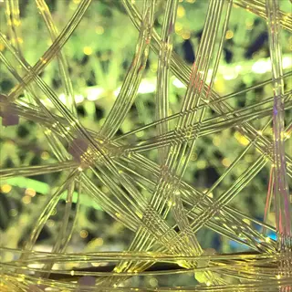 close-up of interconnected glowing fiber optic strands forming a web (fiber optic plant light for horticultural illumination)