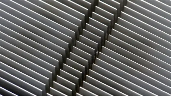 close-up of parallel aluminum heat sink fins for thermal dissipation
