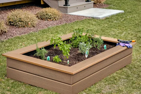 composite lumber garden bed with herb plants, soil, and gardening gloves in a residential backyard. part of composite adjustments for sustainable gardening