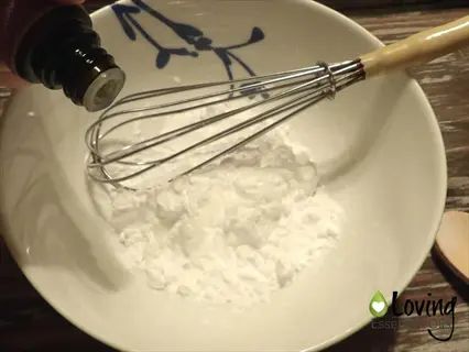 diy baking soda ants repellent preparation: mixing baking soda with essential oil in bowl for natural kitchen pest control | loving essential oils