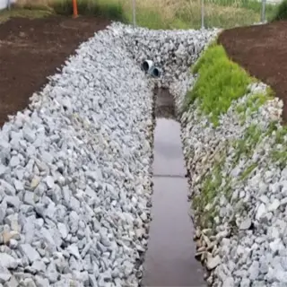 drainage ditch with gravel lining and culvert for drainage enhancement