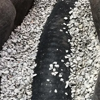 drainage pipe surrounded by gravel in a clay soil setting