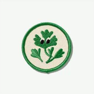 embroidered cilantro spinach patch: stylized green leafy plant design on cream circular background with green border