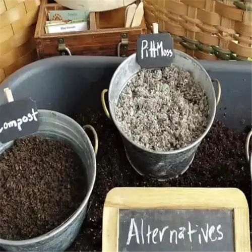 gardening alternatives to peat moss displayed in metal buckets with labels
