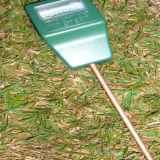 green soil moisture meter on grass