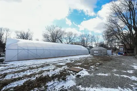 greenhouse structures in a snowy winter garden for growing kale in northern zones (3-5), representing a 'kale snow garden' setup