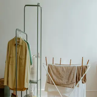 indoor laundry room with a drying rack and clothes