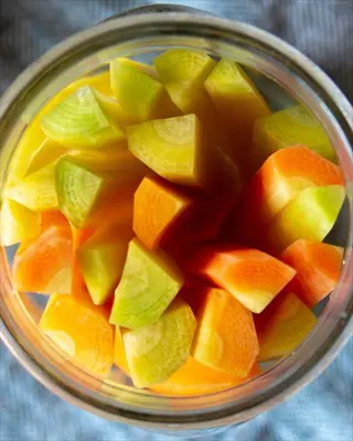 jar of pickled vegetables (colorful carrot pieces) prepared with lemongrass-infused brine