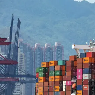 large cargo ship with numerous containers, indicating high container yields