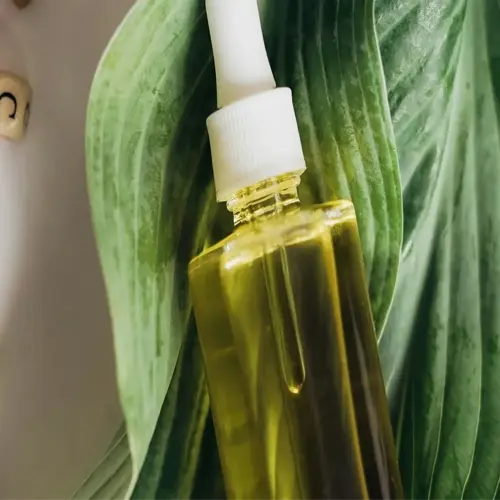 neem oil bottle on green leaves