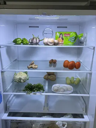 open refrigerator with fresh basil and vegetables - demonstrating basil refrigerator fresh storage with 'chakki fresh' packaging