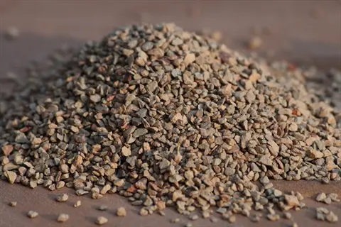 pile of calcined clay soil granules with reddish-brown and gray hues for soil amendment