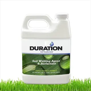plastic jug of duration soil surfactant liquid for agricultural use, labeled with text and water droplets, placed on grass